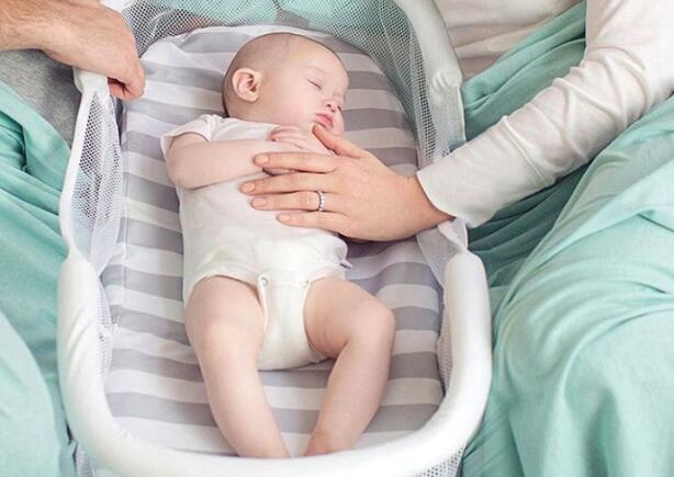 helping newborn sleep in bassinet